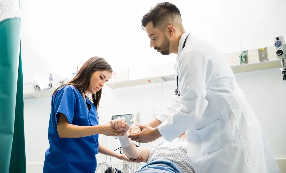 Emergency Medicine locum tenens physician checking out a patient while working in the ER
