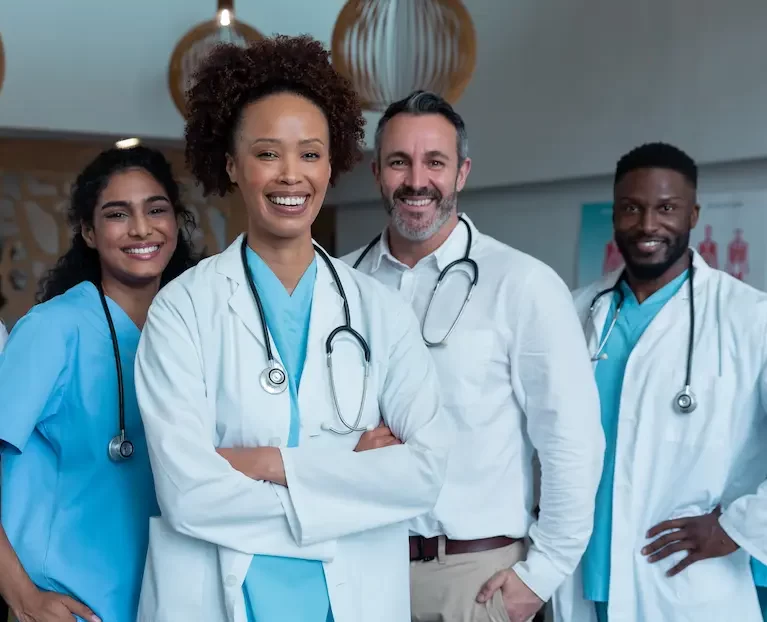 Group of locum tenens healthcare professionals smiling together while in a doctor's office