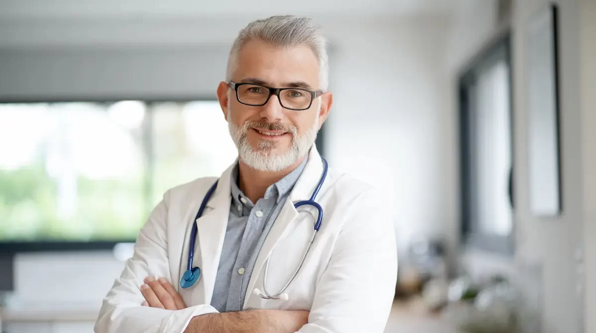 Locum tenens physician smiling and crossing his hands across his chest