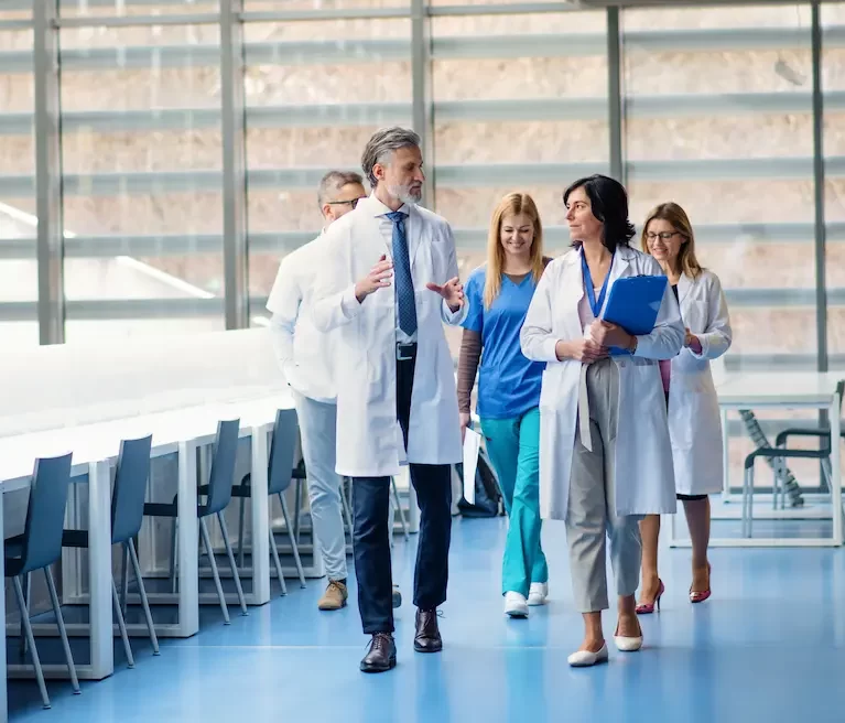 Locum tenens physician walking and talking together in a hospital waiting area
