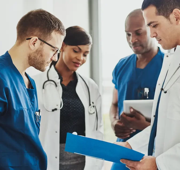 Group of locum tenens physicians looking over documents in a team meeting
