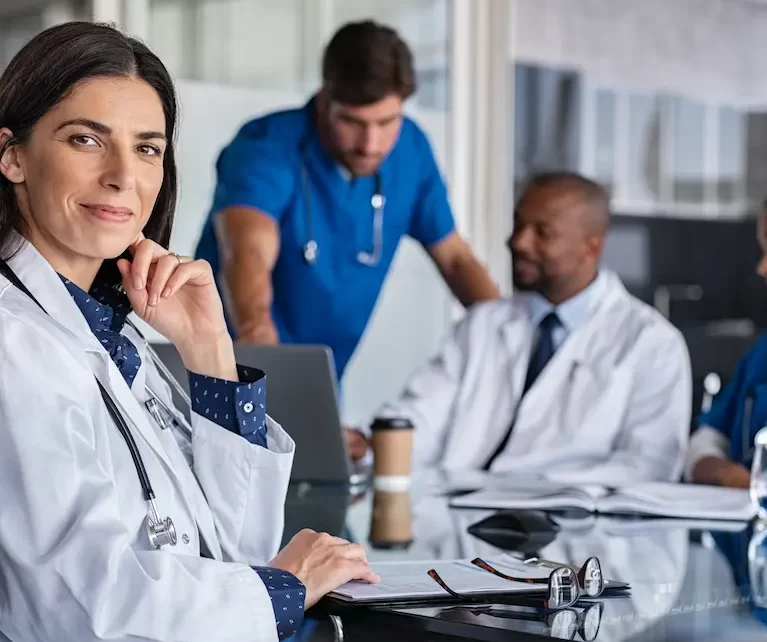 Group of locum tenens sitting at a meeting table chatting