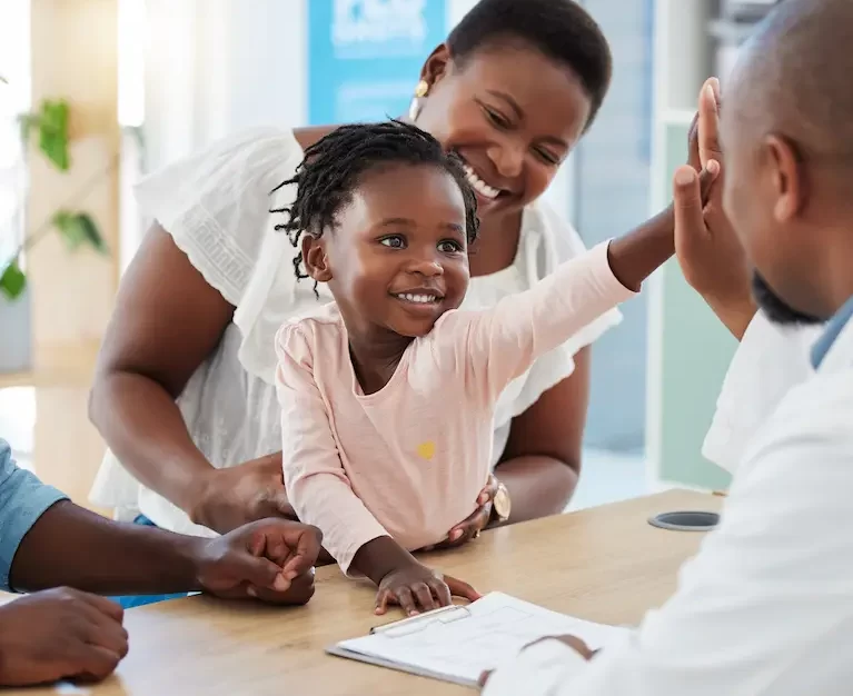Family medicine locum tenens physician high fiving a child with her family