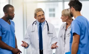 Locum tenens physician speaking to coworkers at the hospital