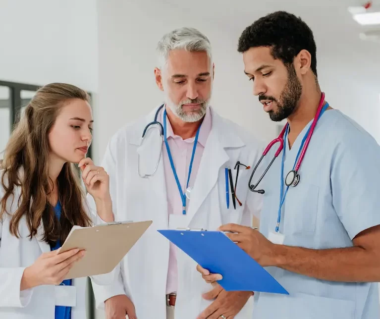 Group of locum tenens professionals looking at charts while at the hospital