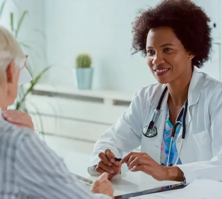 Locum tenens physician speaking to a patient while working in her office